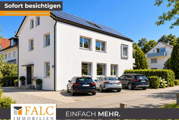 Modernes Mehrfamilienhaus mit Solardach und Fahrzeugen